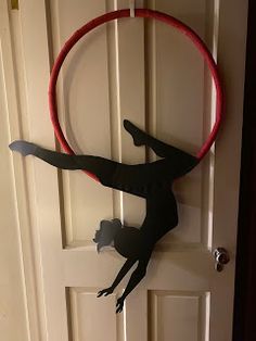 a person is doing tricks in front of a door with a hoop on the wall