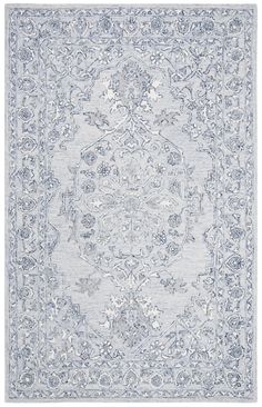 a blue and white rug with an ornate design on the bottom, in front of a white background