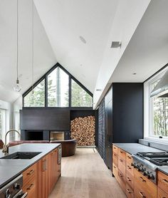 a kitchen with wooden cabinets and an island in front of a stove top oven next to a window