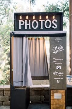 an outdoor photo booth with curtains and lights