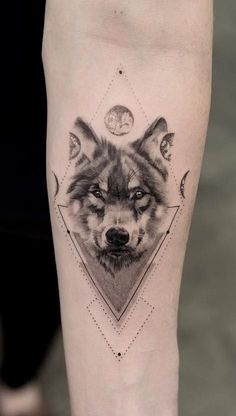 a wolf tattoo on the leg with an image of two different animals in front of it