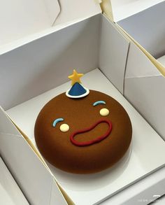 there is a cake in the box with a face on it