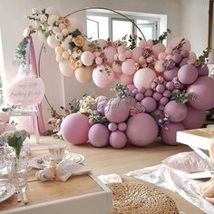 a room with balloons and flowers on the wall