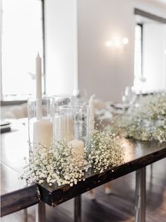 a long table with candles and flowers on it