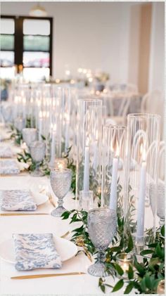 the table is set with candles and place settings