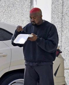 a man in sweatpants and a sweatshirt is holding a tray