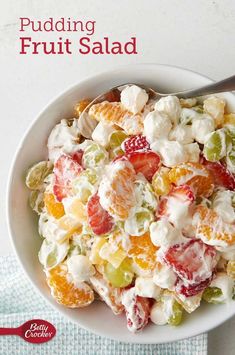 a white bowl filled with fruit salad on top of a table