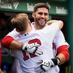 two baseball players hugging each other on the field