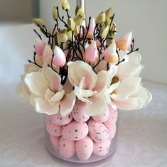 a vase filled with pink and white flowers on top of a table