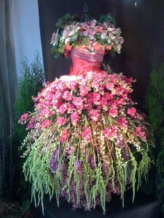 a dress made out of flowers on display