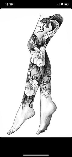 a woman's legs with tattoos and flowers on her leg, in black and white