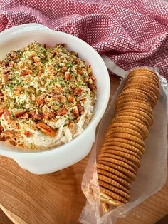 a bowl of dip next to some crackers