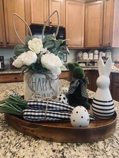 an easter basket with flowers and bunny decorations on the countertop in a home kitchen