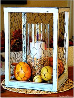 an old window is used as a candle holder to display fruit and other things in it