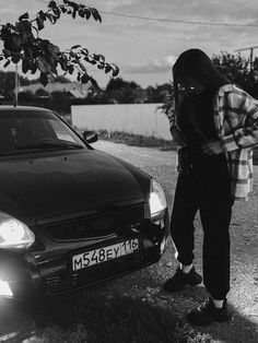 a person standing next to a parked car