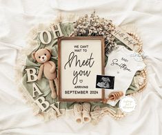 a baby announcement with a teddy bear and other personalized items on top of it