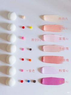 several different colors of toothpaste on a white surface with chinese writing in the middle