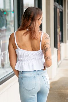 The Easy Does It Babydoll Top offers an easy fit with delicate channeled elastic throughout. The unique detailing on the straps and neckline gives this simple white top some texture, along with the subtle peplum, this top is perfectly flattering and feminine! Pair with your favorite denim jeans, beige carpenter pants, and virtually any pair of shorts! white tank top babydoll style hemline channeled elastic at neckline, straps, and under bust fits true to size, model wears size small 60% rayon, 4 White Smocked Bodice Tank Top, White Smocked Bodice Sleeveless Tank Top, White Feminine Top With Delicate Straps, Feminine Tops With Smocked Bodice And Spaghetti Straps, White Feminine Crop Top With Spaghetti Straps, White Feminine Tank Top With Ruffled Straps, White Spaghetti Strap Top With Smocked Back, White Camisole With Delicate Straps For Day Out, White Tops With Delicate Straps For Day Out