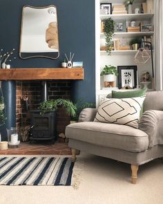 a living room filled with furniture and a fire place in front of a brick fireplace