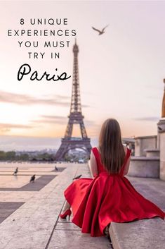 a woman in a red dress sitting on the ground near the eiffel tower with text overlay that reads 8 unique experiences you must try in paris