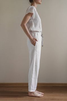 "When ordering you can choose to have the \"PANTS\" or \"TOP\" only or the whole \"PAJAMA SET\" of both items. When buying a set you save 5 euro. Relaxed fit milky white Eva pants with two pockets and fabric strap. Short sleeve AUDREY top with boat neckline. TOP: - length is ± 62 cm (24.4\") (depends on size) - short dolman sleeves - relaxed fit BOTTOM: - outseam is ± 98 cm (38.5\") (depends on size) - inseam is ± 70 cm (27.5\") - elastic waistband with fabric strap - two side pockets DETAILS: - Beige Linen Jumpsuits And Rompers For Loungewear, White Jumpsuits And Rompers For Spring Lounging, Casual White Jumpsuits And Rompers For Loungewear, White Jumpsuit For Spring Lounging, Casual Cotton Jumpsuits And Rompers For Sleep, Casual Spring Sleep Jumpsuits And Rompers, Casual Cream Sleepwear For Home, Casual Cream Jumpsuits And Rompers For Loungewear, White Linen Loungewear Sets