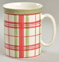 a red and green plaid coffee mug on a white background