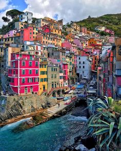 colorful buildings line the hillside above a body of water