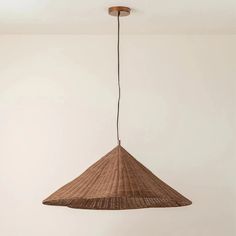 a hanging lamp made out of woven material in a room with white walls and flooring