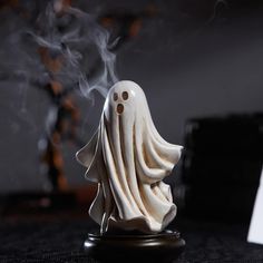 a white ghost statue sitting on top of a table