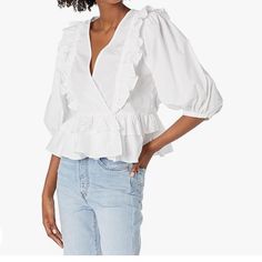 Full Volumen And With Ruffles, The Nellis Tops Is A Must-Have For The Season With A Plungging V-Neck. Chic V-neck Top For Spring Brunch, Fitted V-neck Top For Spring Day Out, Fitted Cotton V-neck Top For Spring, Chic V-neck Top For Brunch In Spring, Spring Day Out Cotton V-neck Top, Chic Cotton V-neck Top For Day Out, Spring Cotton V-neck Top For Day Out, Fitted V-neck Top For Spring, Floral Print Summer Top