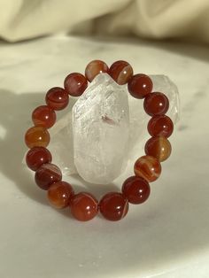 "This listing includes one 10mm Carnelian bracelet. Each bracelet is made to order. All bracelets are made to be 6.5\" inches long, however, if you would like a customized longer/shorter size, make sure to add on the resize listing on my Etsy page. Feel free to send us a message for any questions. Thank you!   All photos are taken in natural daylight to capture all of the variations of colors and reflections.  ☾ Please keep in mind that crystals are natural gifts made from mother nature and beau Boho Bachelorette Party, Boho Bachelorette, Carnelian Bracelet, Carnelian Jewelry, Carnelian Crystal, Carnelian Necklace, Red Bracelets, Natural Gifts, Crystal Bracelet