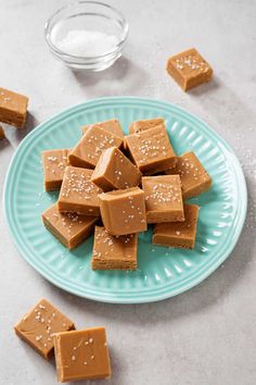 a plate full of peanut butter fudges on a table with salt and pepper