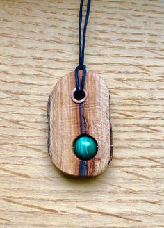 Wood pendant created from the fallen branches of the Lansdowne Sycamore. This tree is still growing and was germinated in the mid 1600s That puts this tree at around 400 years old! Other material used is a 10mm malachite bead and a copper tube rivet. Unique Natural Wood Pendant Jewelry, Rustic Pendant Necklace For Healing, Copper Tube, Malachite Pendant, Carving Patterns, Wood Carving Patterns, Copper Tubing, Wooden Projects, Wire Work Jewelry