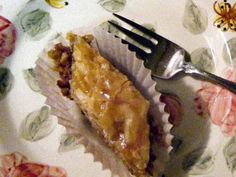 a piece of pie sitting on top of a plate next to a knife and fork