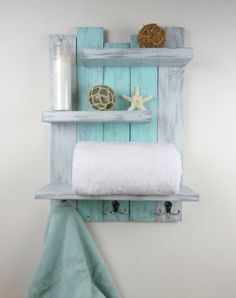 a towel rack made out of pallet wood with two shelves holding towels and other items