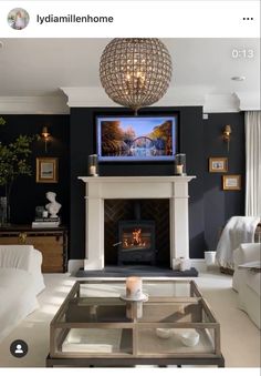 a living room filled with furniture and a flat screen tv mounted above a fire place