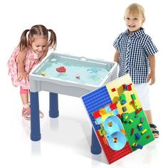 two young children playing with a lego table and chair set in the shape of a pool