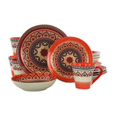 an orange and white dinnerware set with paisley designs