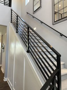 a staircase with metal handrails and mirrors on the wall