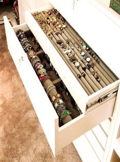 an open drawer is shown with jewelry in it