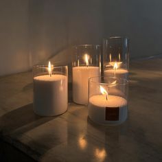 three lit candles sitting on top of a table