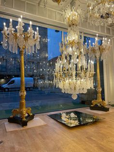 a chandelier hanging from the ceiling in front of a window