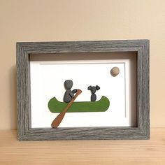 Pebble Art Person in a Canoe with Dog This Canoe Pebble Art piece is a unique gift for the nature lover in your life!  The piece was created using gatherings our family has made along the shores of Lake Huron, Canada. The 5x7" design is 6x8" fully framed.  It can hang on a wall or stand on its own. Each pebble art piece is constructed of authentic, quality materials, including: -hand-picked beach pebbles, -hand-selected beach driftwood, -hand-harvested plants which are then dried, -archival qual Art Person, Beach Pebbles, Moving Gifts, Lake Huron, Retirement Gifts, Pebble Art, Mixed Media Collage, Bridal Shower Gifts, Hand Picked