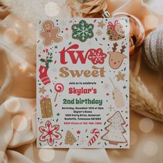 a white and red christmas themed birthday party card with gingerbreads, snowflakes, trees, and other holiday decorations