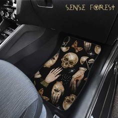 the inside of a car with skulls and hands on it's front floor mat