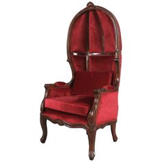 an old fashioned chair with red velvet upholstered on the back and armrests