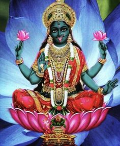 the hindu god sitting on top of a lotus flower with his hands in each hand