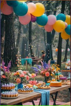 an outdoor party with colorful balloons and desserts