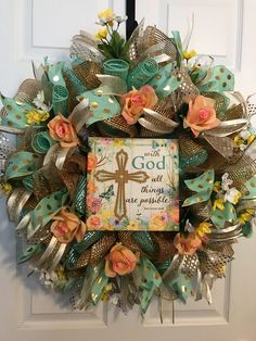 a wreath with an image of a cross and flowers on it that says, we are god all things are possible