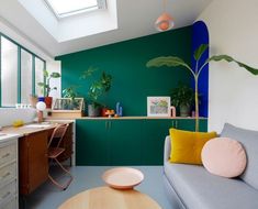 a living room filled with furniture and green walls